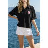 Polo éponge noir et surpiqûres rose